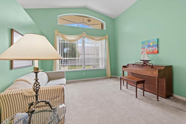 sitting room with light carpet and vaulted ceiling