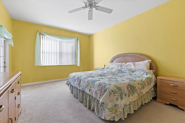 carpeted bedroom with multiple windows and ceiling fan