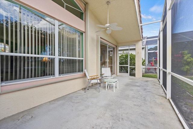 unfurnished sunroom with vaulted ceiling and ceiling fan