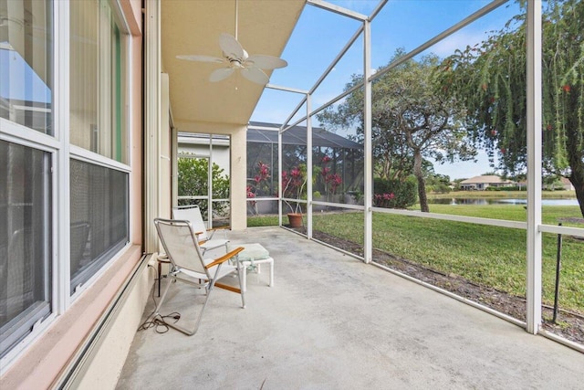 unfurnished sunroom featuring ceiling fan