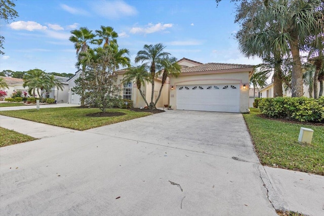 view of front of property featuring a front yard and a garage