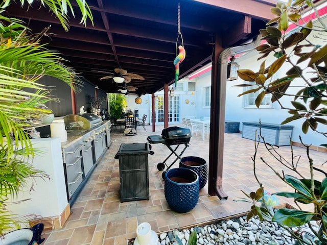 view of patio featuring an outdoor kitchen, ceiling fan, and a grill