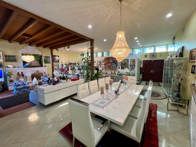 dining area with a notable chandelier, light tile floors, and beamed ceiling