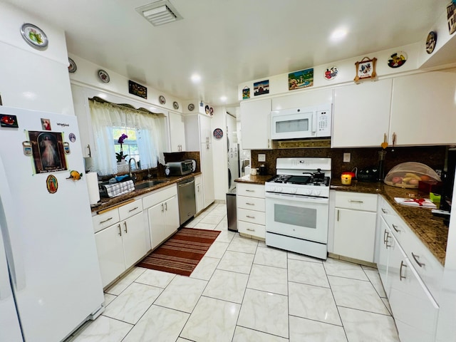 kitchen featuring backsplash, white appliances, white cabinetry, and light tile floors