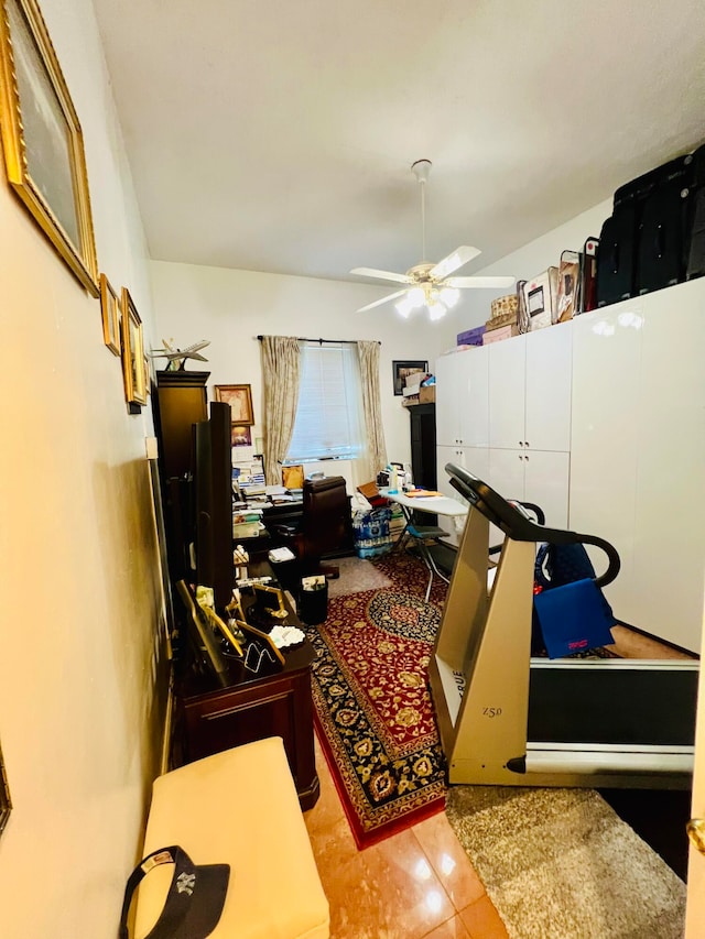 tiled home office featuring ceiling fan