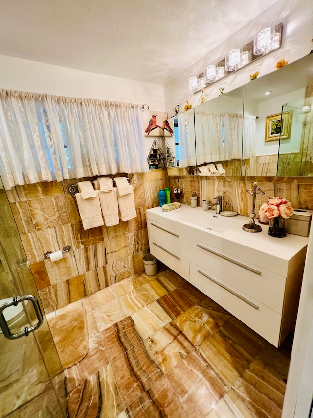 bathroom featuring tile walls, tile flooring, and vanity