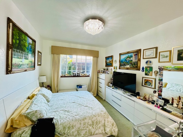 bedroom featuring carpet flooring and an inviting chandelier