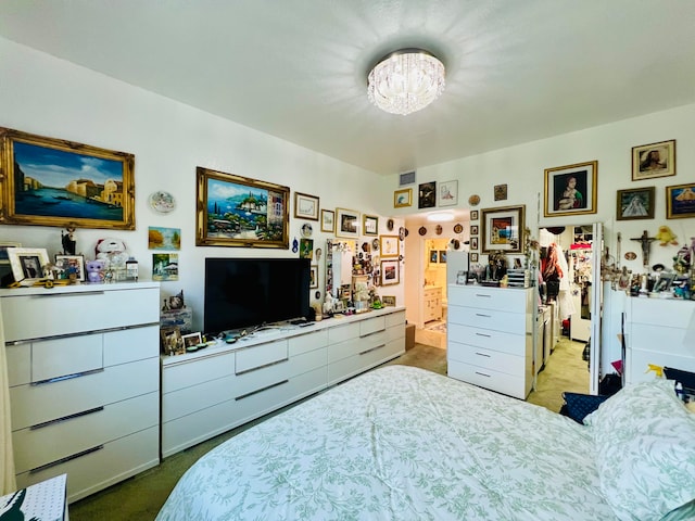 carpeted bedroom featuring a chandelier