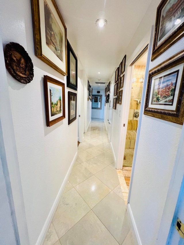 corridor featuring light tile floors