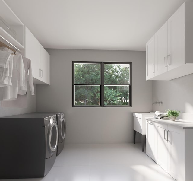 washroom featuring light tile floors, cabinets, and washing machine and dryer