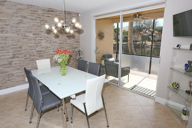 tiled dining area featuring a textured ceiling and ceiling fan with notable chandelier