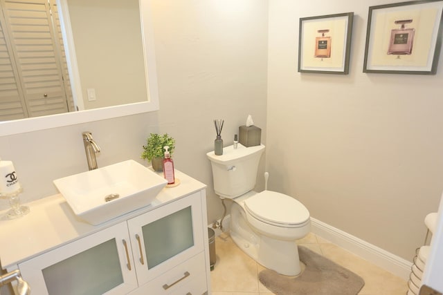 bathroom featuring toilet, tile floors, and oversized vanity