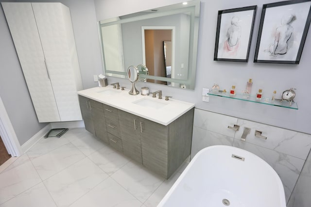 bathroom featuring tile walls, double vanity, tile flooring, and a bathing tub