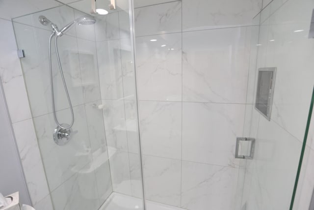 bathroom featuring a shower with shower door