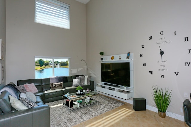 tiled living room with a towering ceiling