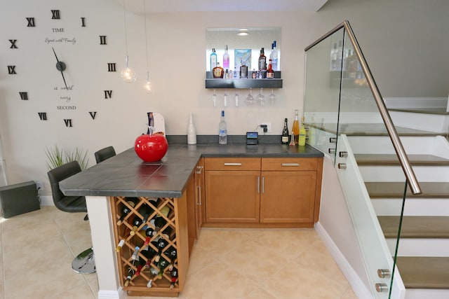 bar featuring pendant lighting and light tile floors