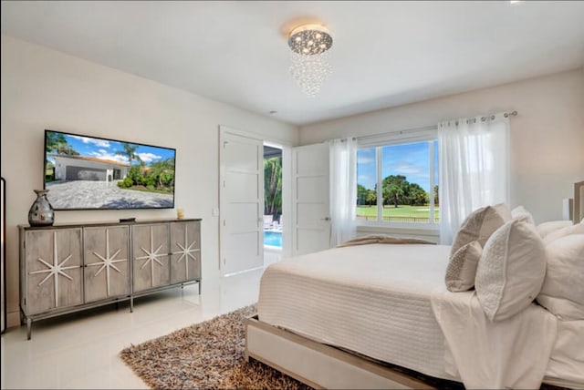 tiled bedroom with a chandelier