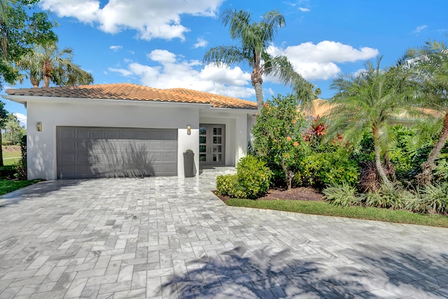 mediterranean / spanish home with a garage