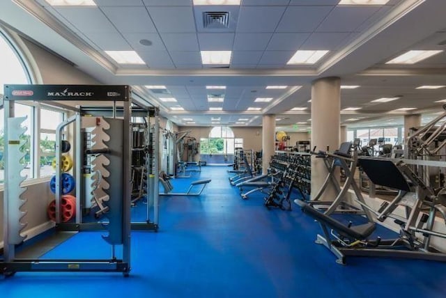 workout area featuring a drop ceiling and a healthy amount of sunlight