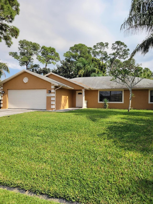 ranch-style house featuring a front lawn and a garage