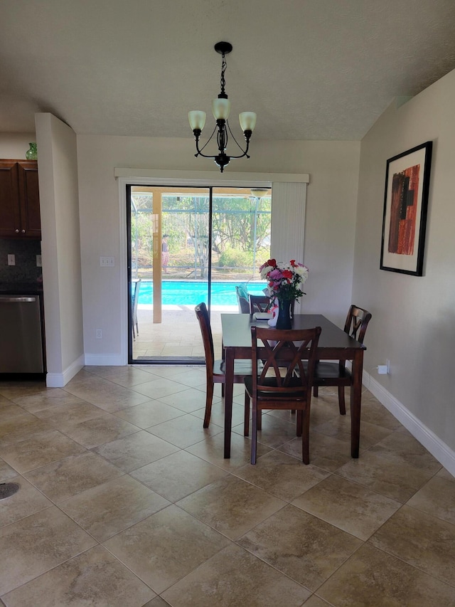 tiled dining space with a chandelier