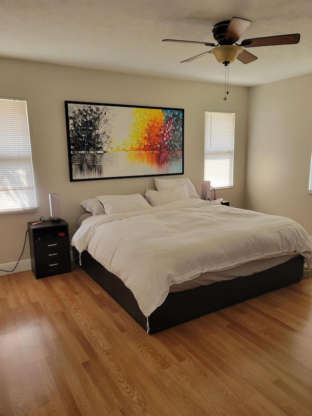 bedroom featuring ceiling fan and light wood-type flooring