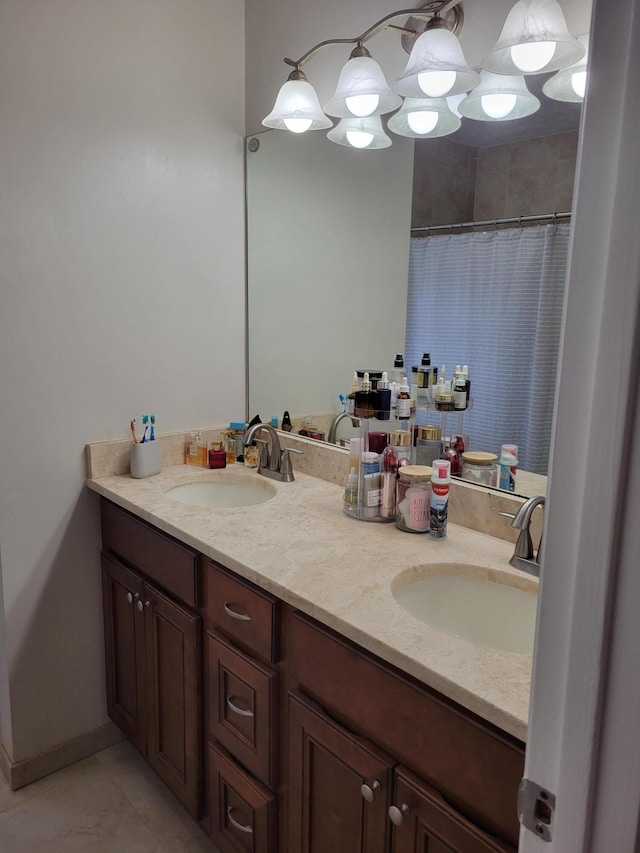 bathroom with double sink, tile floors, and large vanity