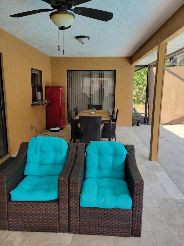 view of terrace featuring an outdoor living space and ceiling fan