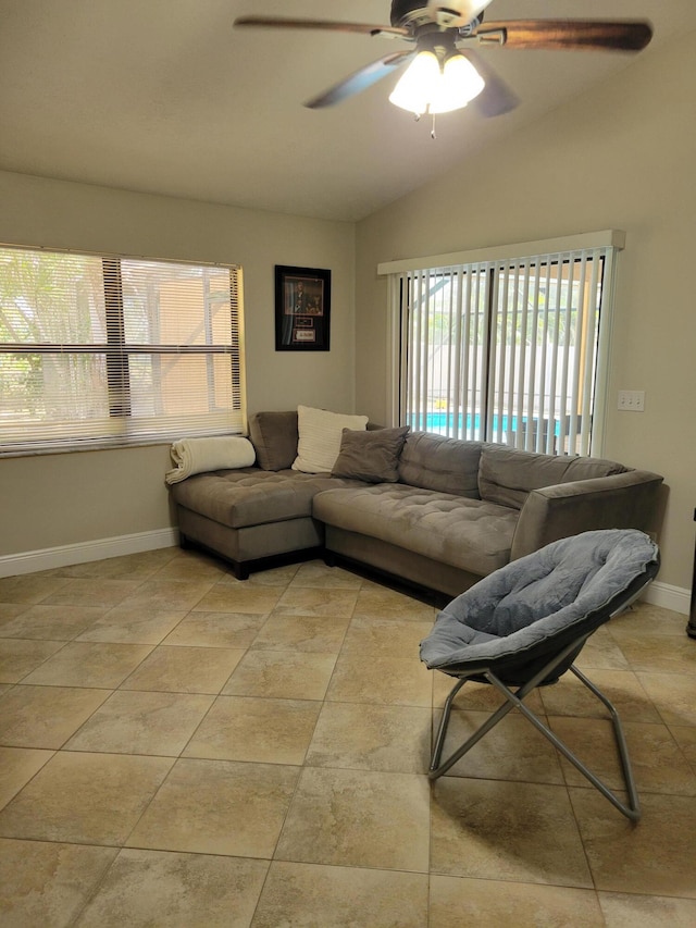 living room featuring light tile flooring, vaulted ceiling, and ceiling fan