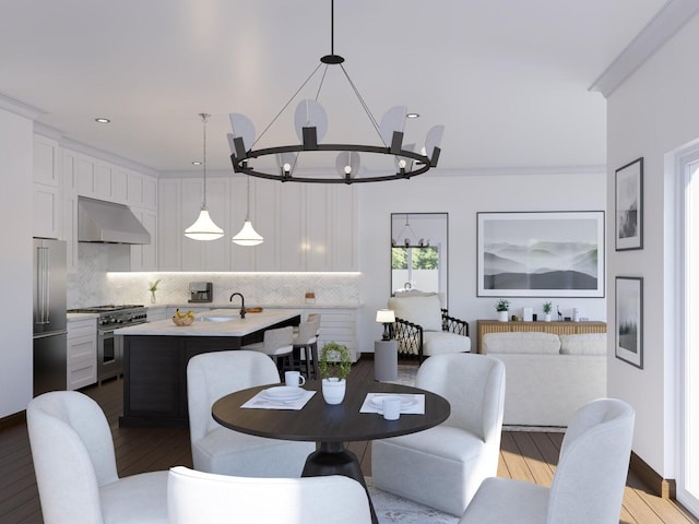 dining space featuring an inviting chandelier, sink, and light hardwood / wood-style flooring