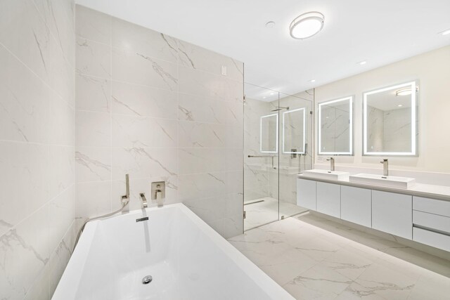 bathroom featuring double vanity, tile floors, and a shower with shower door