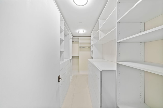 walk in closet featuring light tile floors