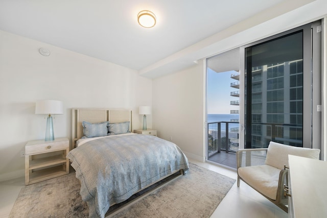 bedroom featuring access to exterior and a water view