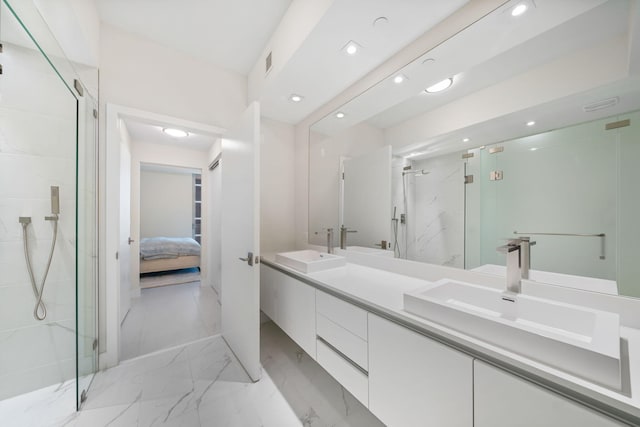 bathroom with a shower with door, tile flooring, and double vanity