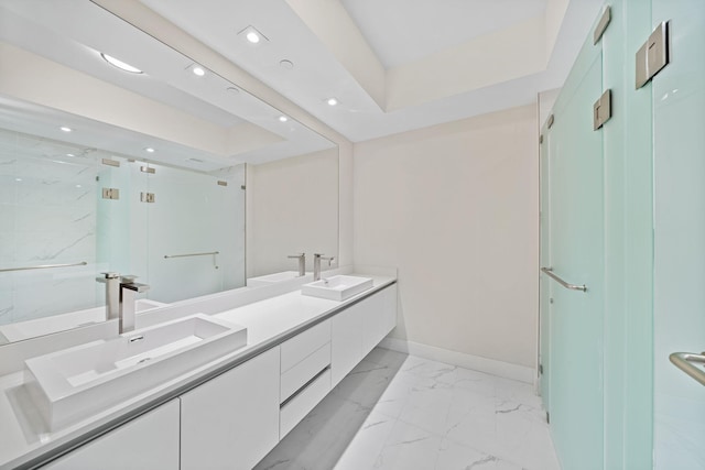 bathroom featuring an enclosed shower, double sink, large vanity, and tile flooring