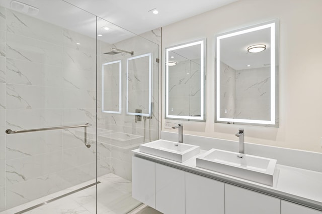 bathroom with double sink vanity and a shower with shower door