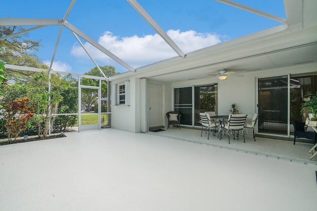 unfurnished sunroom featuring ceiling fan