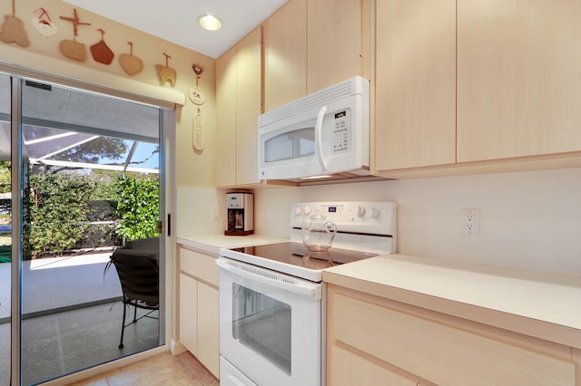 kitchen with white appliances, light brown cabinetry, and light tile flooring