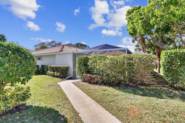 view of front of home featuring a front yard and a lanai