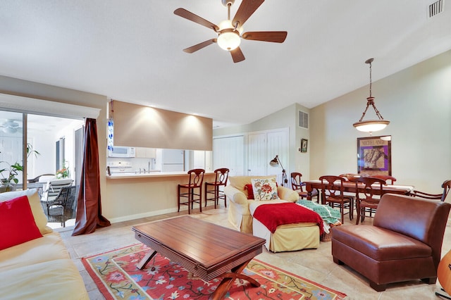 tiled living room with lofted ceiling and ceiling fan