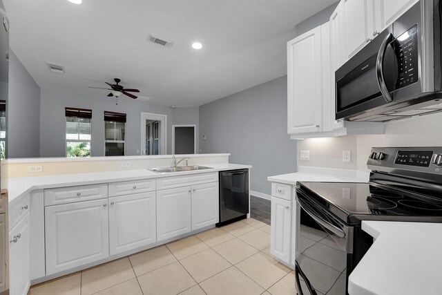 kitchen with stainless steel appliances, white cabinetry, sink, light tile patterned floors, and ceiling fan