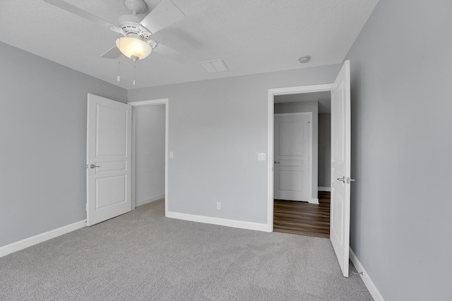 unfurnished bedroom featuring ceiling fan and carpet