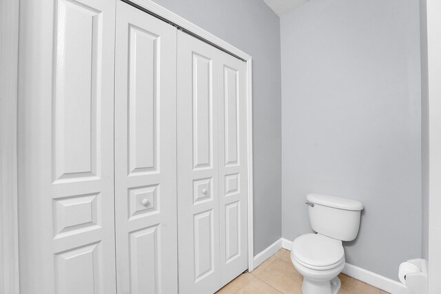 bathroom featuring toilet and tile patterned floors