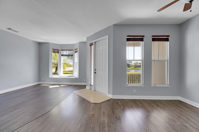 foyer entrance with hardwood / wood-style floors, a textured ceiling, and ceiling fan