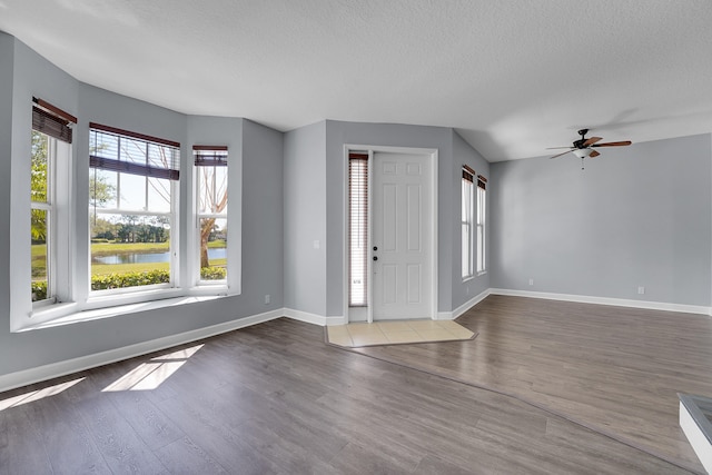 entryway featuring ceiling fan, a textured ceiling, and hardwood / wood-style floors