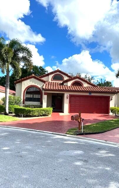 mediterranean / spanish home featuring a garage