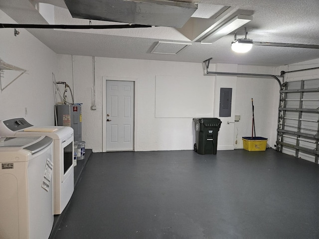 garage featuring water heater, washing machine and dryer, and electric panel