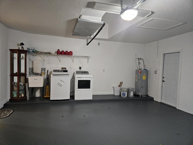 garage with a sink, washing machine and dryer, and electric water heater