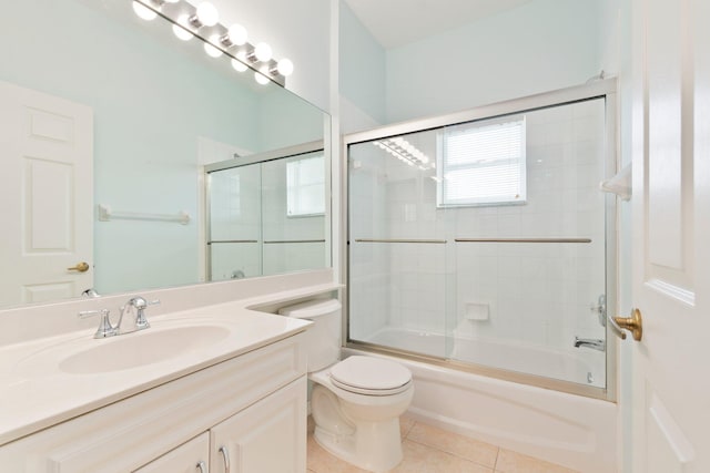 full bathroom with toilet, combined bath / shower with glass door, vanity, and tile patterned flooring