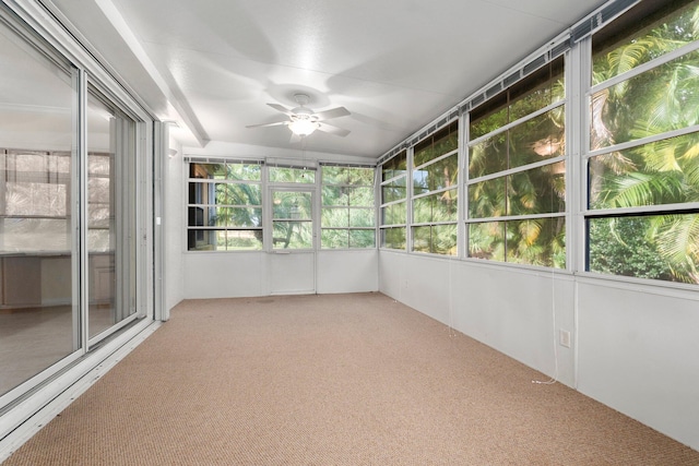 unfurnished sunroom with a healthy amount of sunlight and ceiling fan